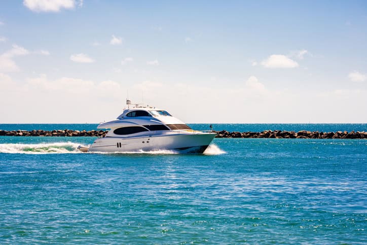 Yacht sailing on sea waters. Luxury superyacht at sea. Miami Beach with yachts. Seascape with a sailboat. Cruise ship near the coastline. Sunset yacht voyage in Florida. Luxury sailboat yacht